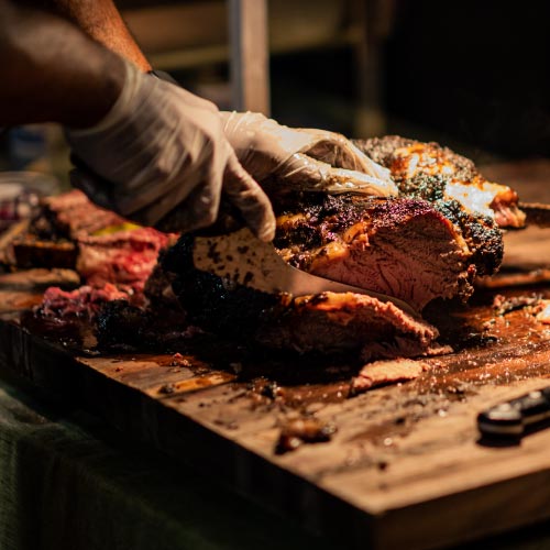 Sliced smoked brisket by Izzy's BBQ catering