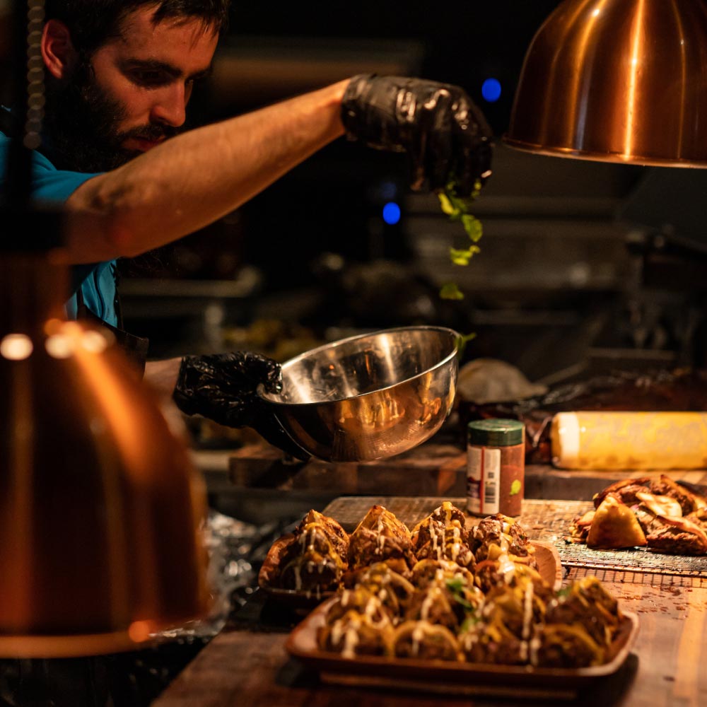 Izzy's catering team preparing smoked meats for an event